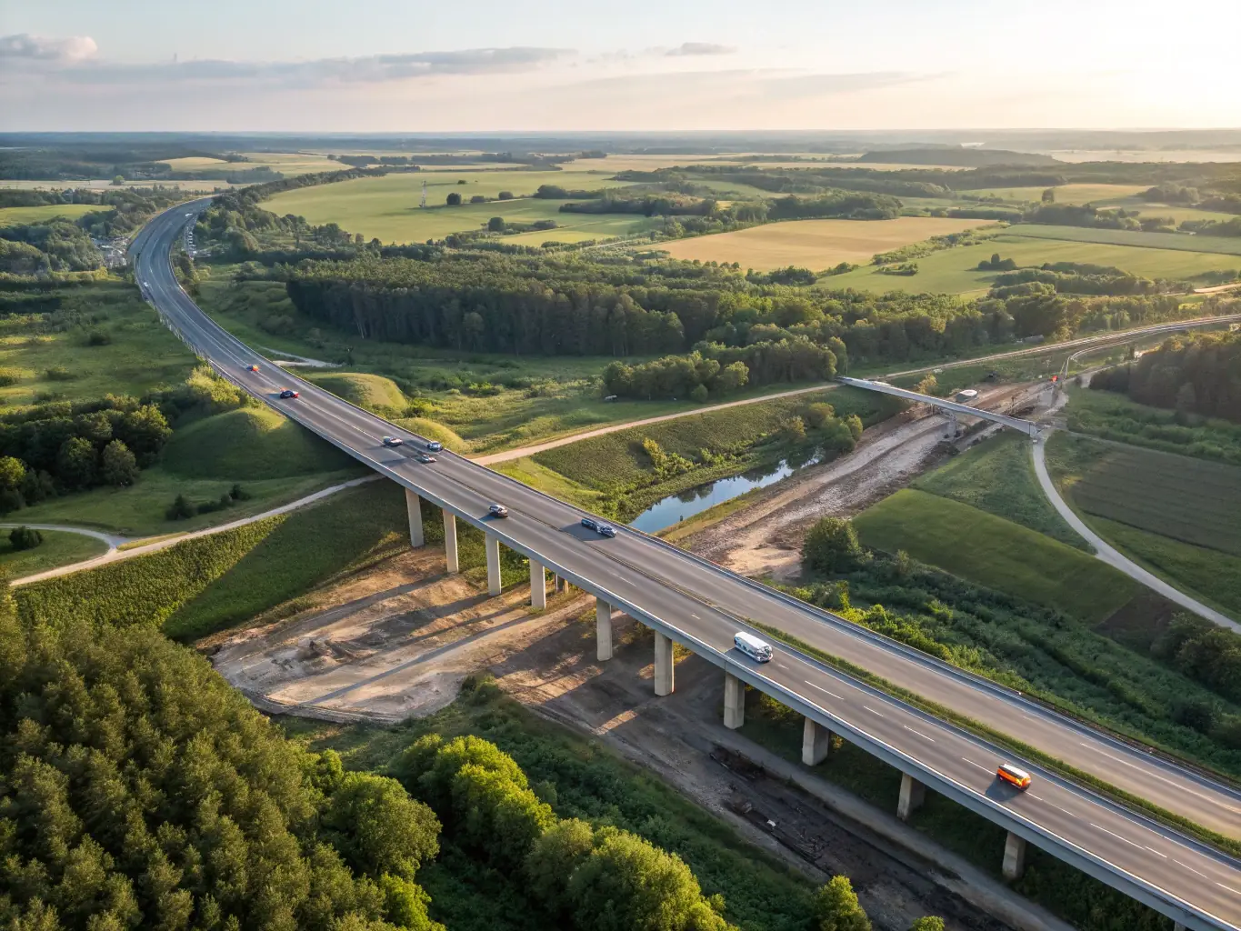 An aerial view of a large-scale civil works project, such as a highway interchange or a water treatment plant, highlighting the scope and complexity of civil engineering.